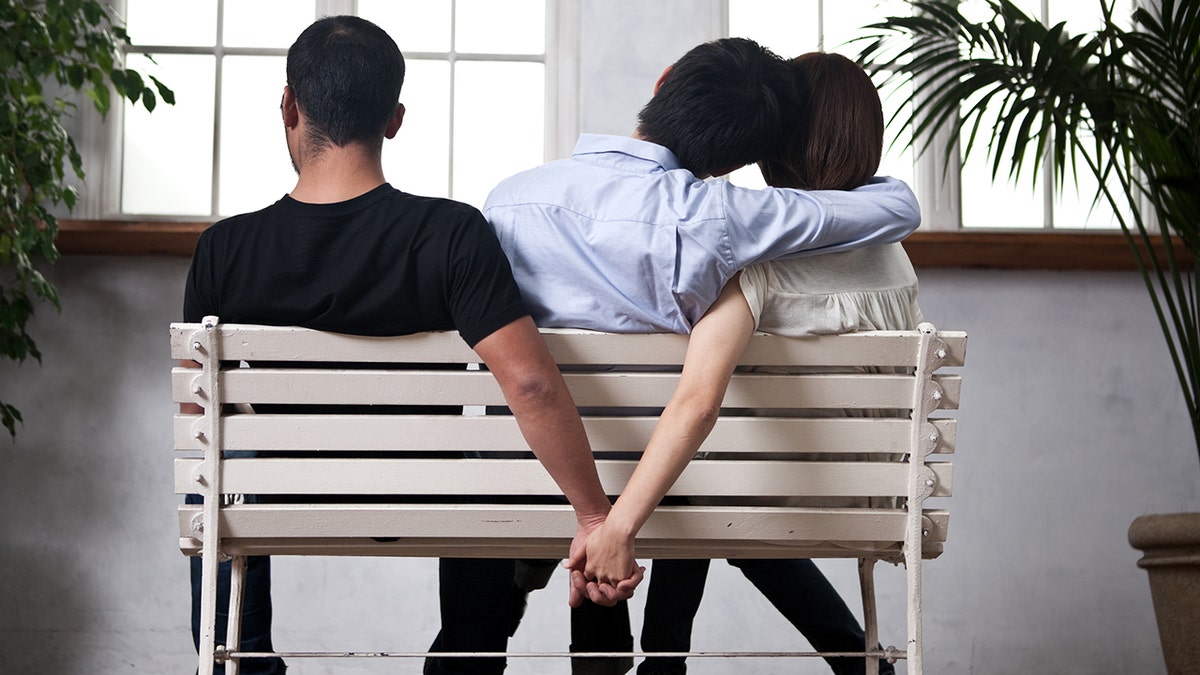 Young woman and man holding their hands behind the seat