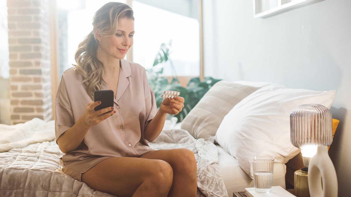 Mature woman waking up and using products for hormone replacement therapy