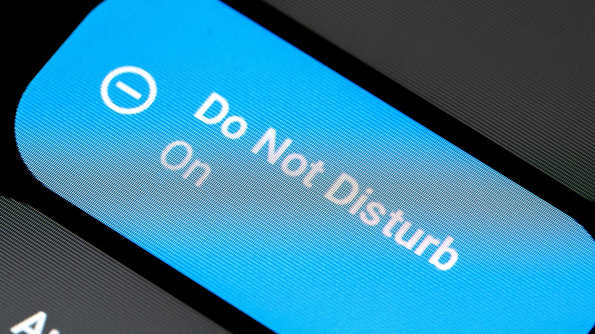 A close-up of a smartphone device screen showing that Do Not Disturb mode is enabled