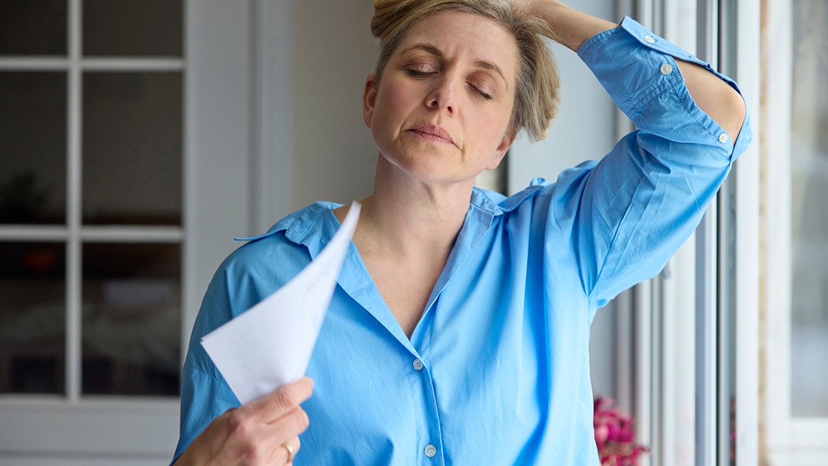 Menopausal Woman Having Hot flash At Home