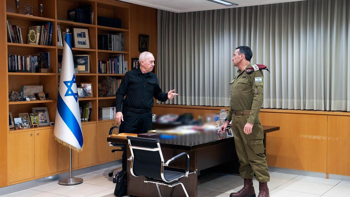 Israeli Minister of Defense Yoav Gallant, left, conducts a situation assessment.?