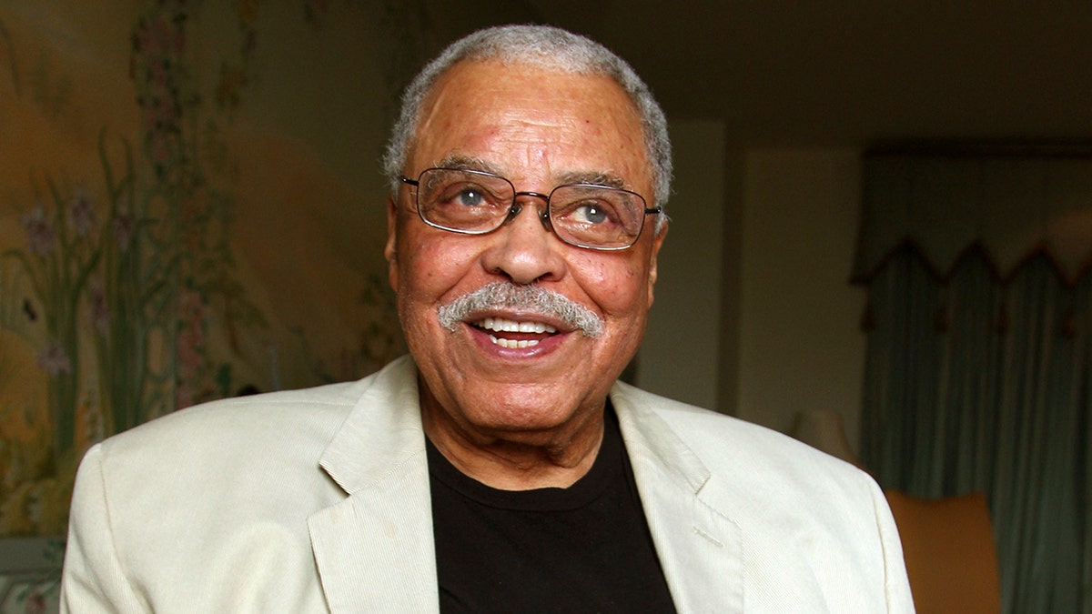 Actor James Earl Jones wears tan suit and black shirt