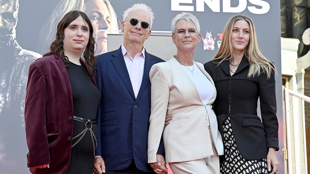 Jamie Lee Curtis holds hands with husband Christopher Guest at the Halloween premiere.