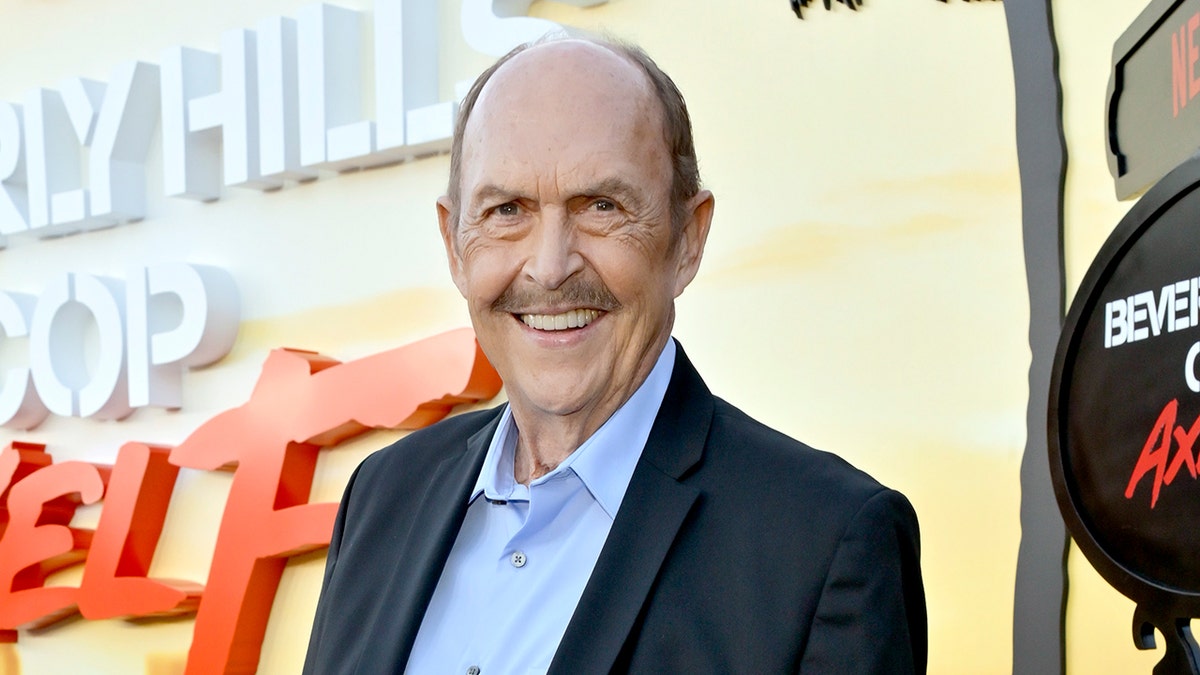 Actor John Ashton wears a blazer and a blue shirt at the "Beverly Hills agent: Axel F" premiere