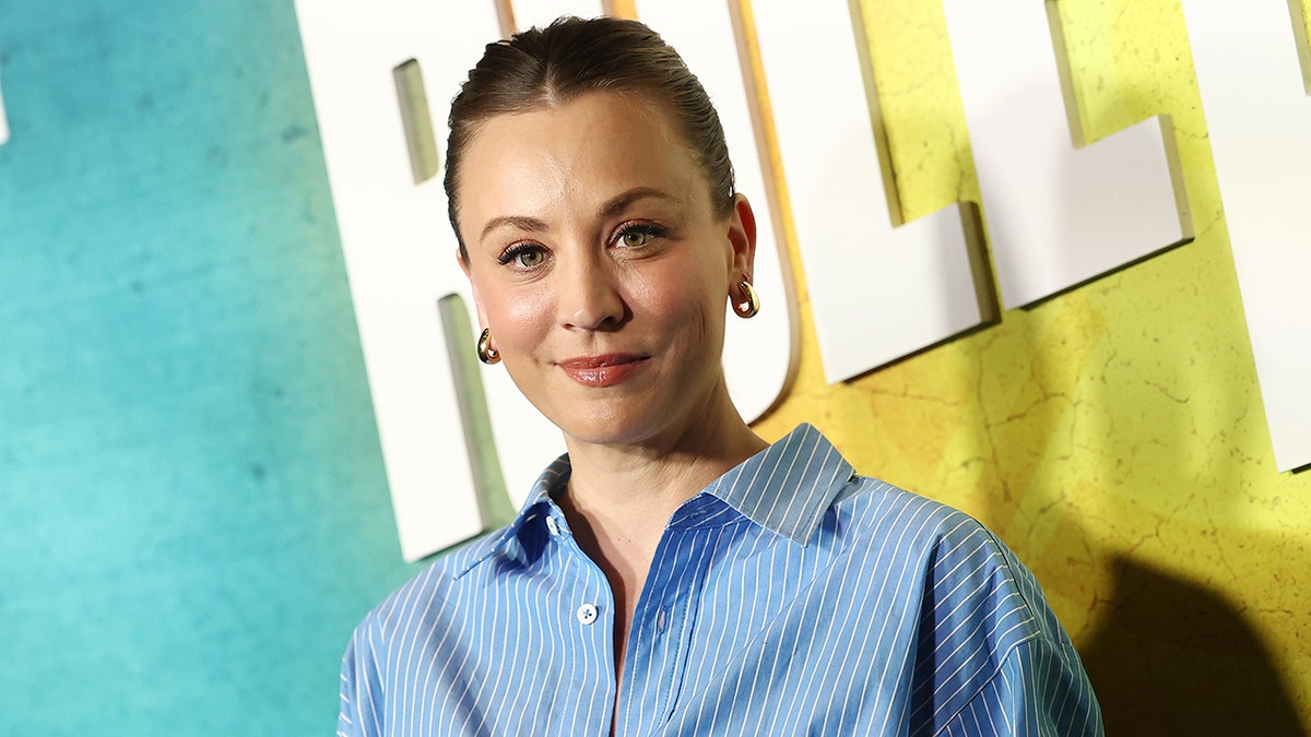 Kaley Cuoco brushed  smiles connected  the carpet wearing a bluish  and achromatic  striped shirt