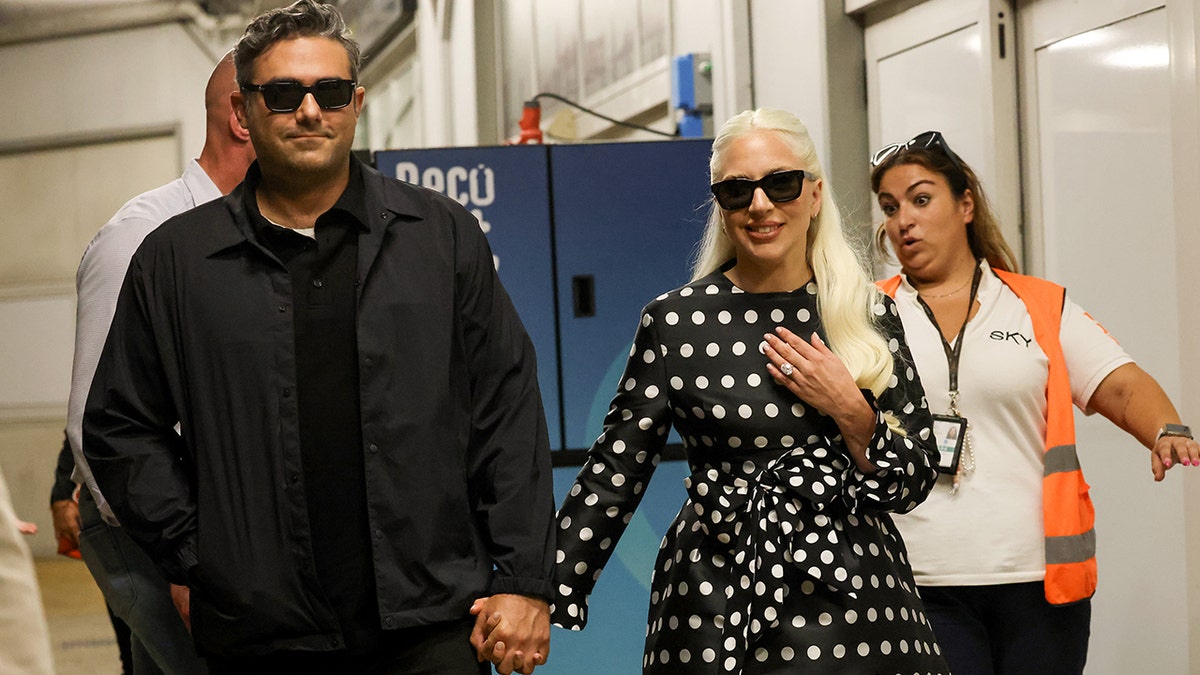 Lady Gaga shows off her engagement ring while walking with fiancé Michael Polansky