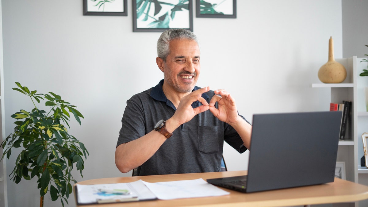 A man learning sign language