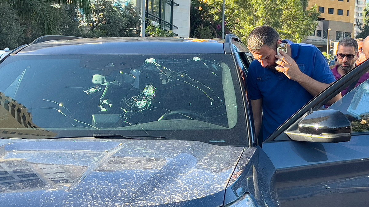 Police officers inspect the car