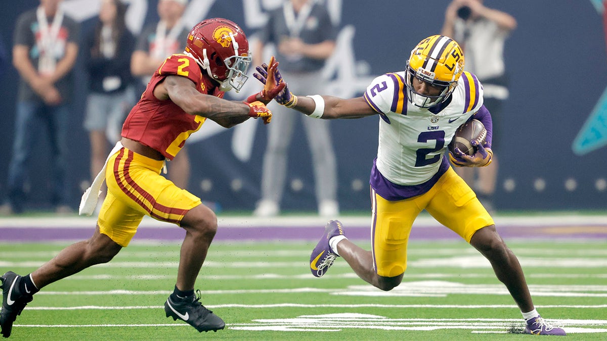 Kyren Lacy fends off a tackle