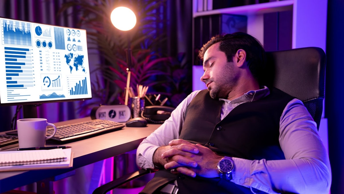 Man sleeping in front of computer