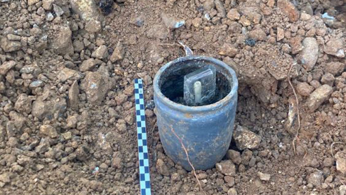 Message and bottle inside a clay pot