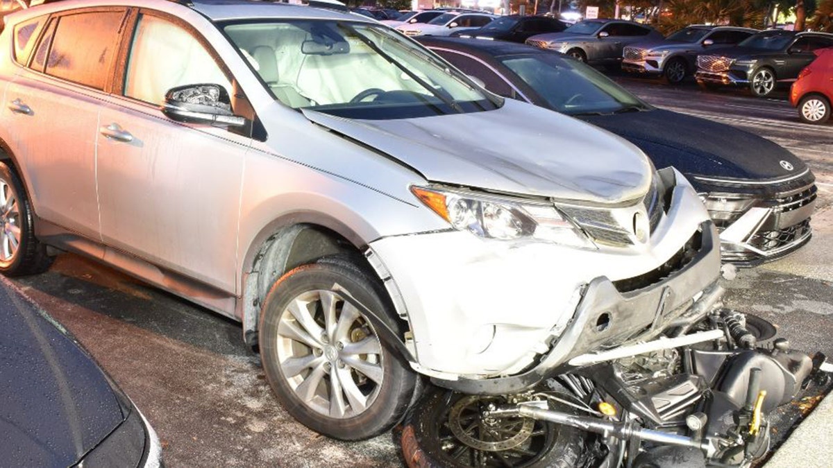 The motorcycle under the car