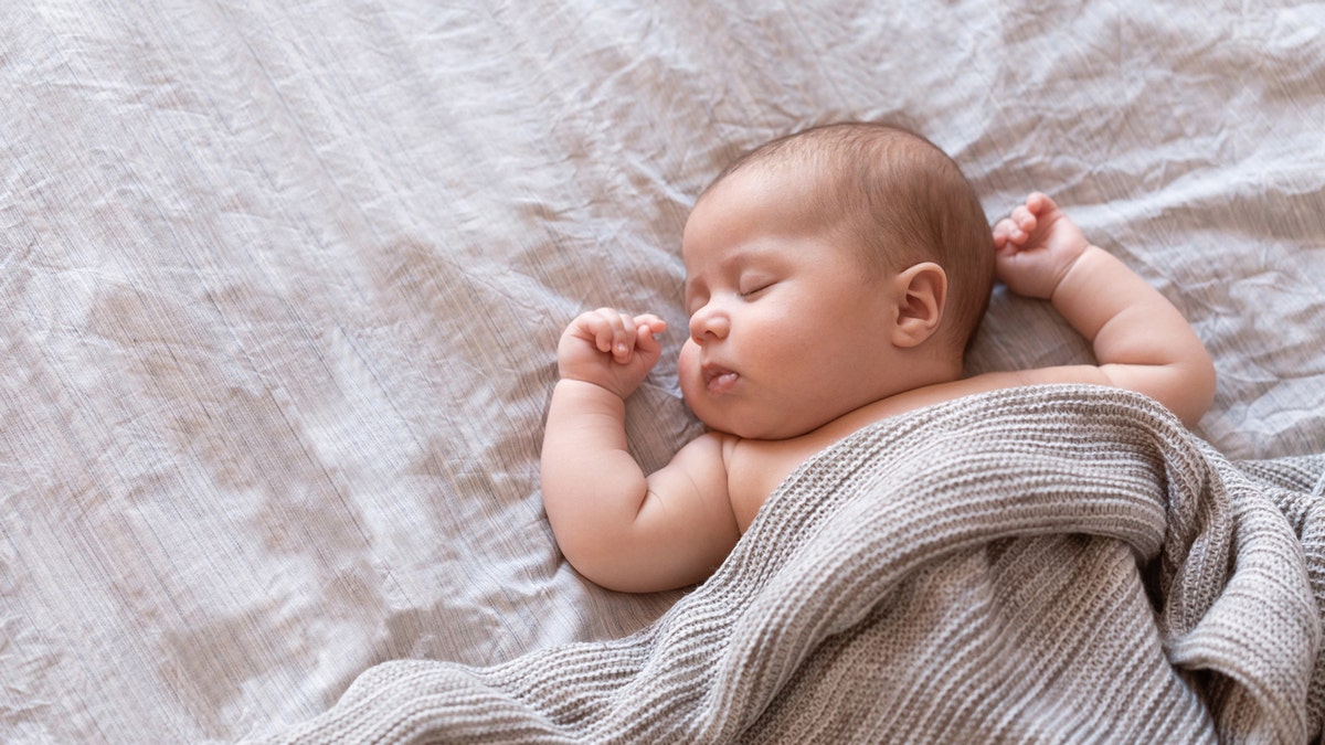 Newborn babe  sleeping successful  bed