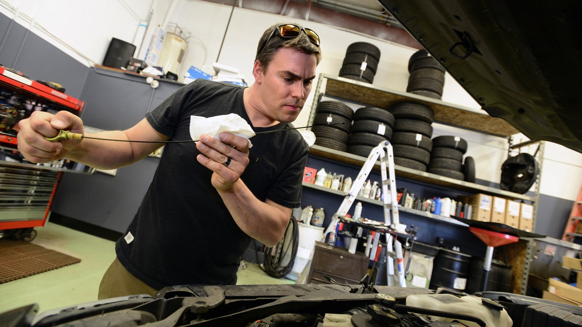 Man changing oil in car