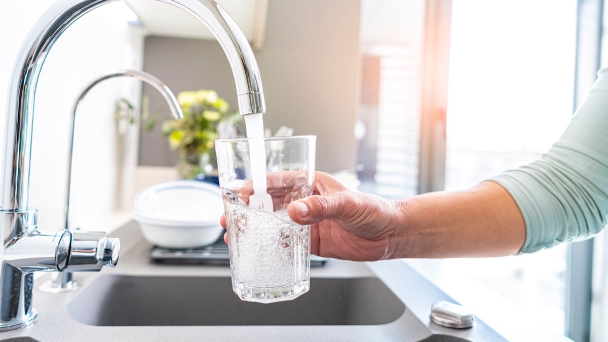 Mujer llenando agua del grifo