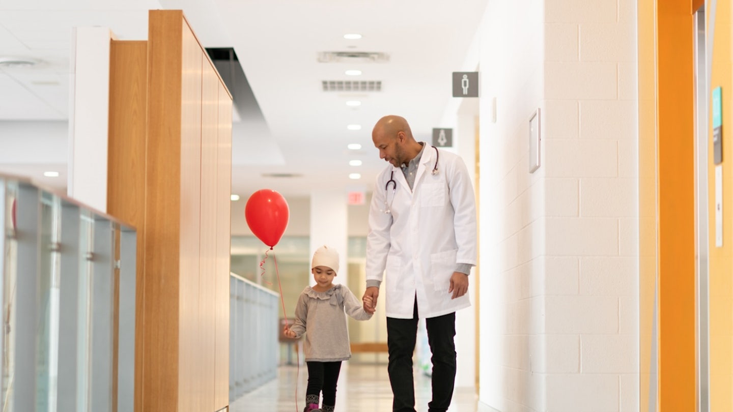 child walking with doctor