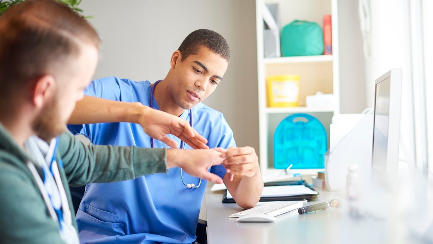 doctor examining hand