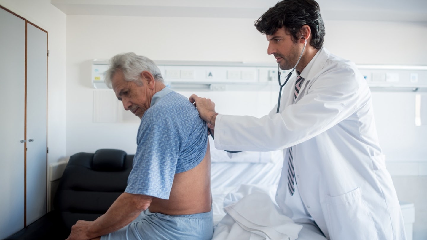 doctor listening to patients lungs