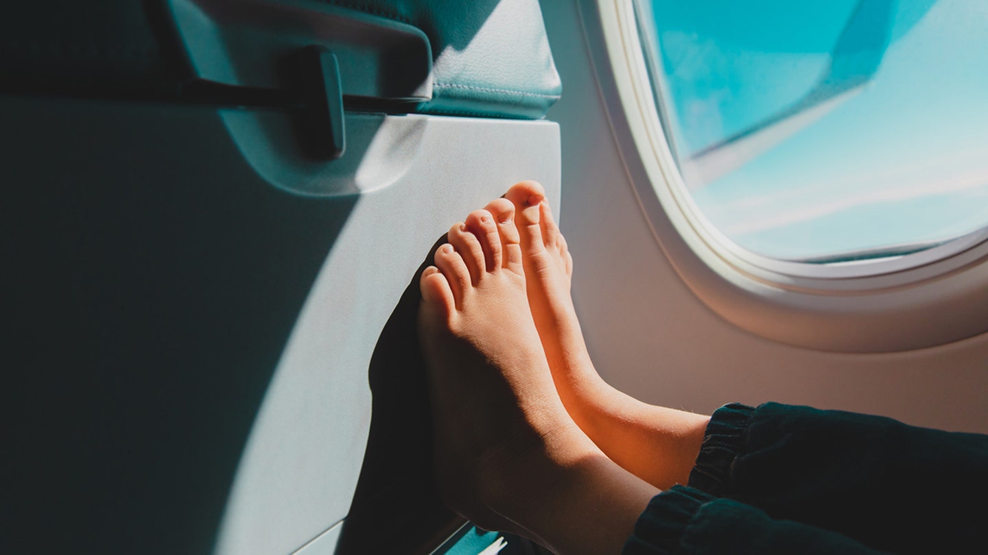 feet on the back of airplane seat