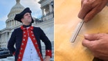 AJ Jacobs in colonial regalia outside Capitol building and sharpening quill