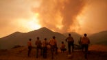 Firefighters monitor the advancing Line Fire in Angelus Oaks, Calif., Monday, Sept. 9, 2024. (AP Photo/Eric Thayer)