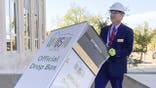 In this photo provided by Wausau Mayor Doug Diny, Diny uses a dolly to remove the city's lone drop box from in front of City Hall in Wausau, Wis., on Sunday, Sept. 22, 2024.