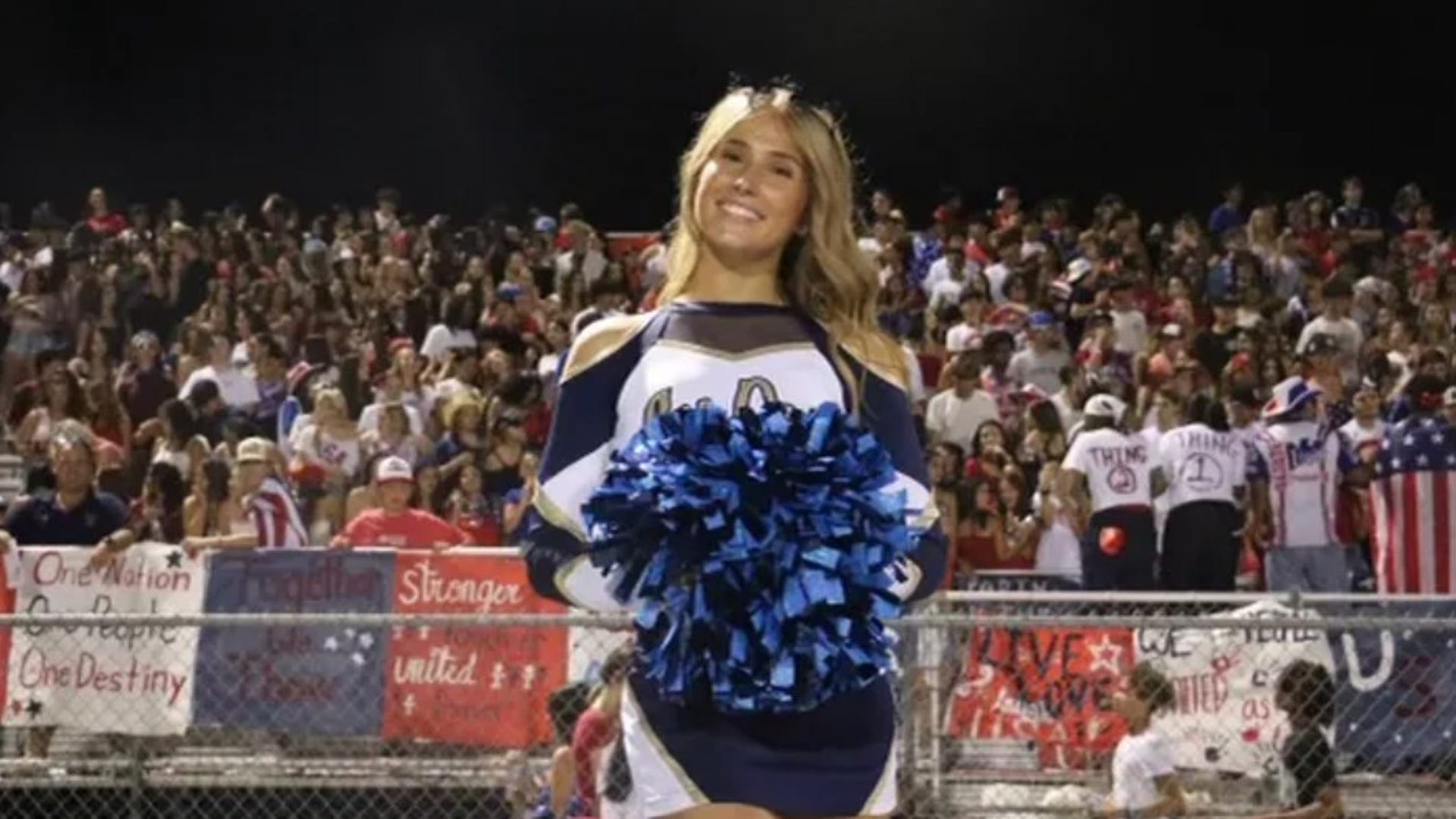 Emily Gold in a high school cheerleading uniform.