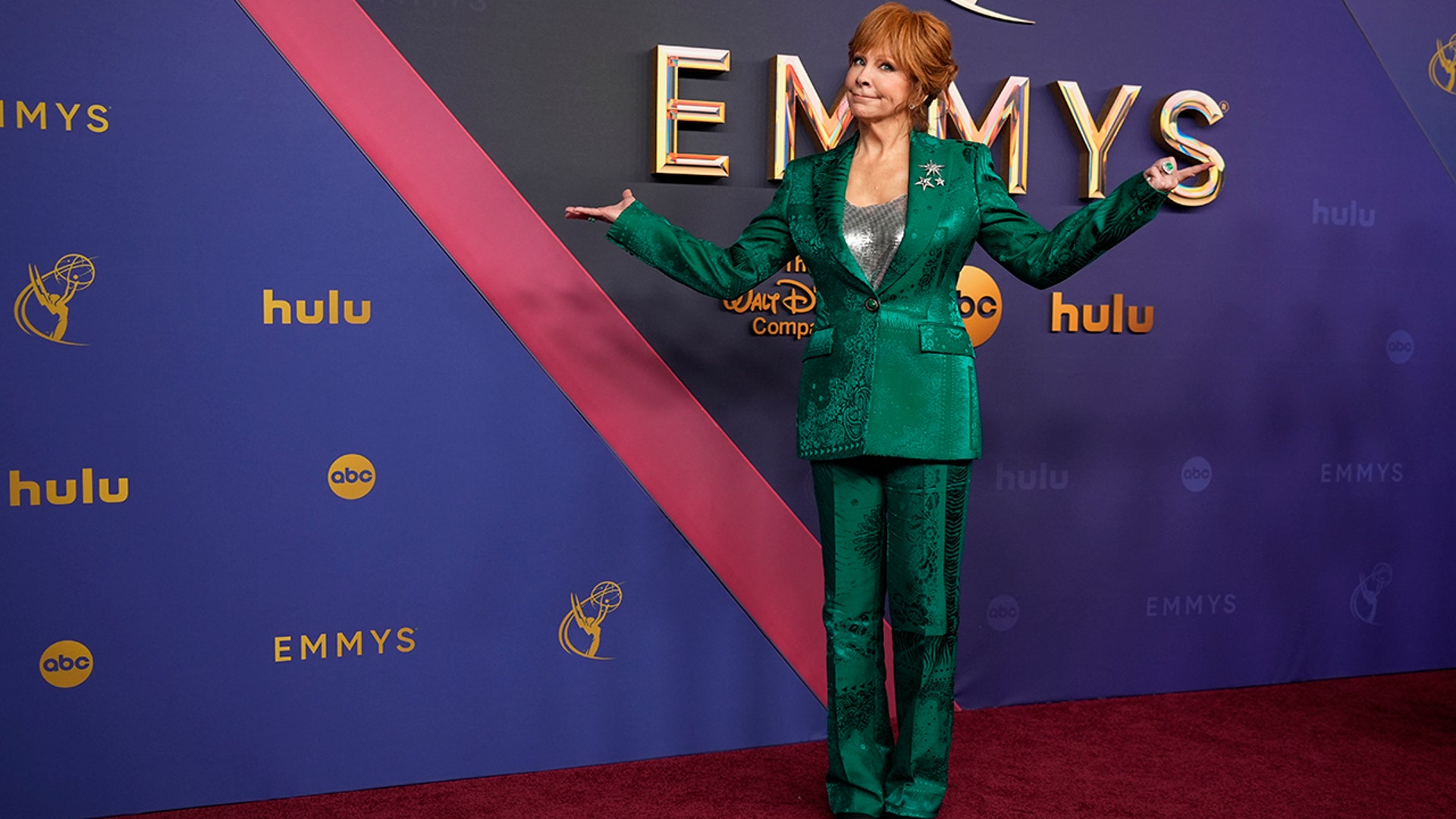 Reba McEntire walked the red carpet at the 2024 Emmy Awards in a green suit.