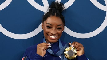 Simone Biles acknowledges diamond-studded GOAT necklace 'p---es people off'