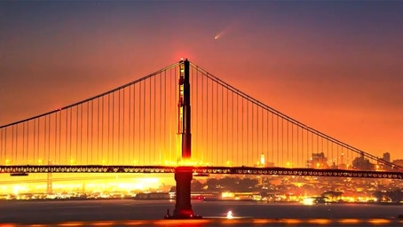 Comet makes appearance over San Francisco's Golden Gate Bridge during sunrise