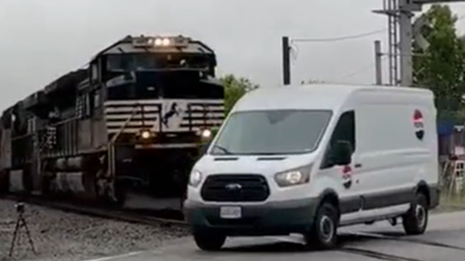 Video captures van narrowly avoiding being hit by an oncoming train