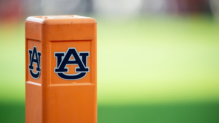 Auburn cheerleader knocks down Oklahoma player running onto field while performing stunts thumbnail