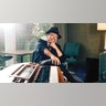 Sergio Mendes sits by a keyboard