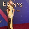 Christine Baranksi, nominated for her role in "The Gilded Age," in a gold gown on the red carpet at the 2024 Emmy Awards.