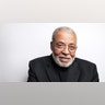 Award-winning actor James Earl Jones wears black suit.