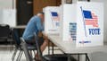 A man fills out a ballot at a voting booth on May 17, 2022 in Mt. Gilead, North Carolina. Georgias Secretary of State&rsquo;s Office said it stopped a cyberattack that targeted the states absentee voter website. - Fox News
