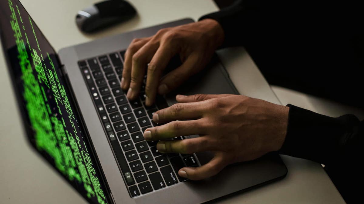 person typing on a laptop