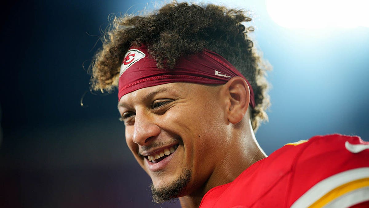 Patrick Mahomes smiles on field