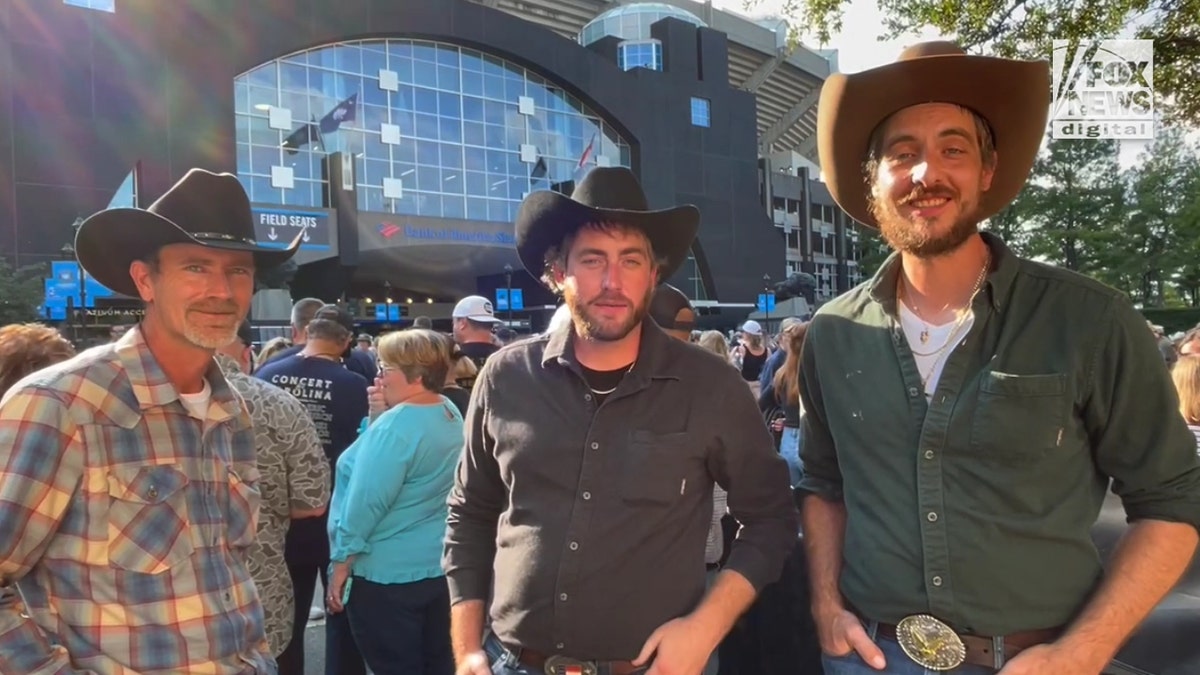 Three concertgoers from Greensboro wearing cowboy hats.