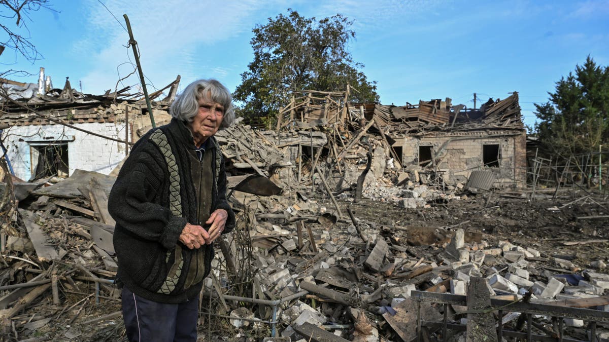 woman standing in rubble
