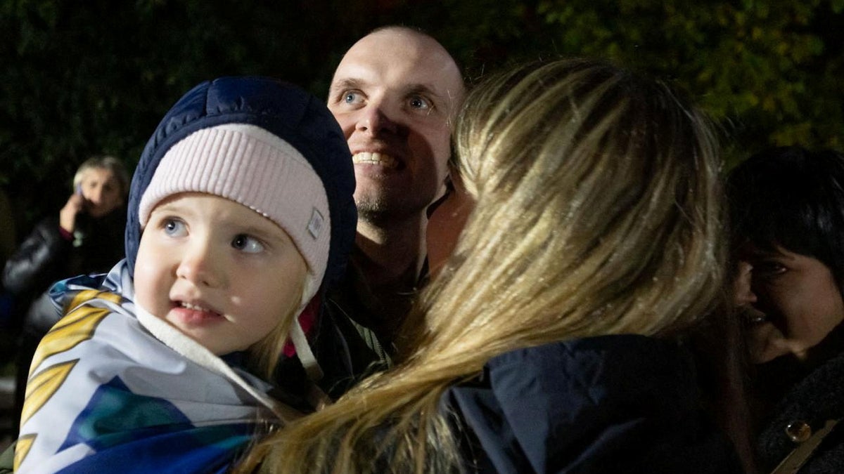 A freed Ukrainian prisoner of war is shown with his relatives after a swap at an undisclosed location in this handout picture obtained on Oct. 19, 2024. (Ukrainian Presidential Press Service/via Reuters)