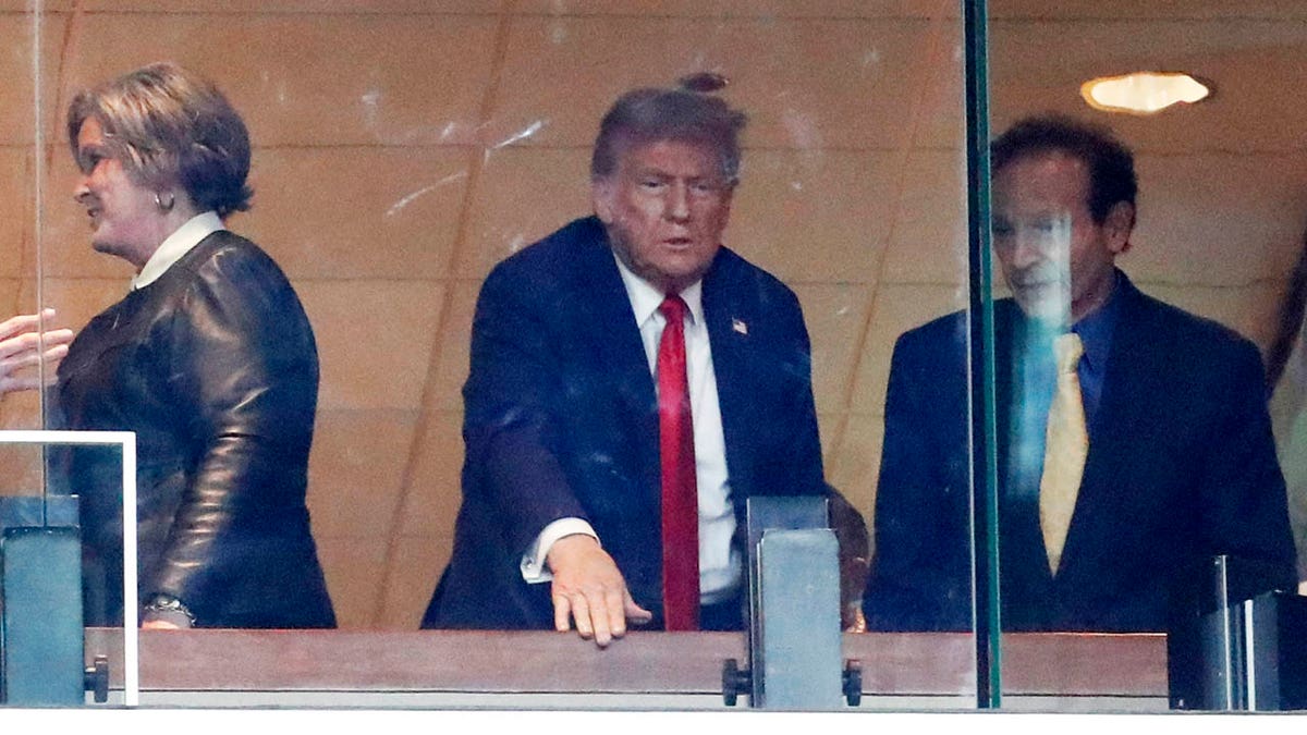 Donald Trump reacts to the Steelers fans from the suite