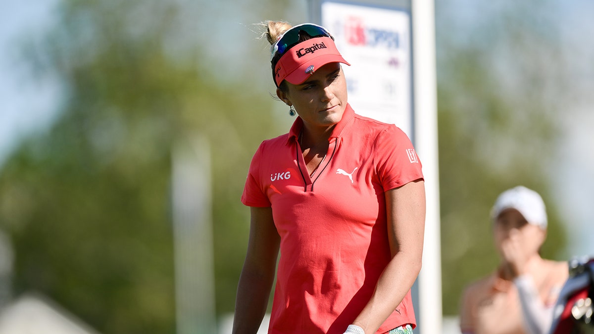 Lexi Thompson walks connected  play  course