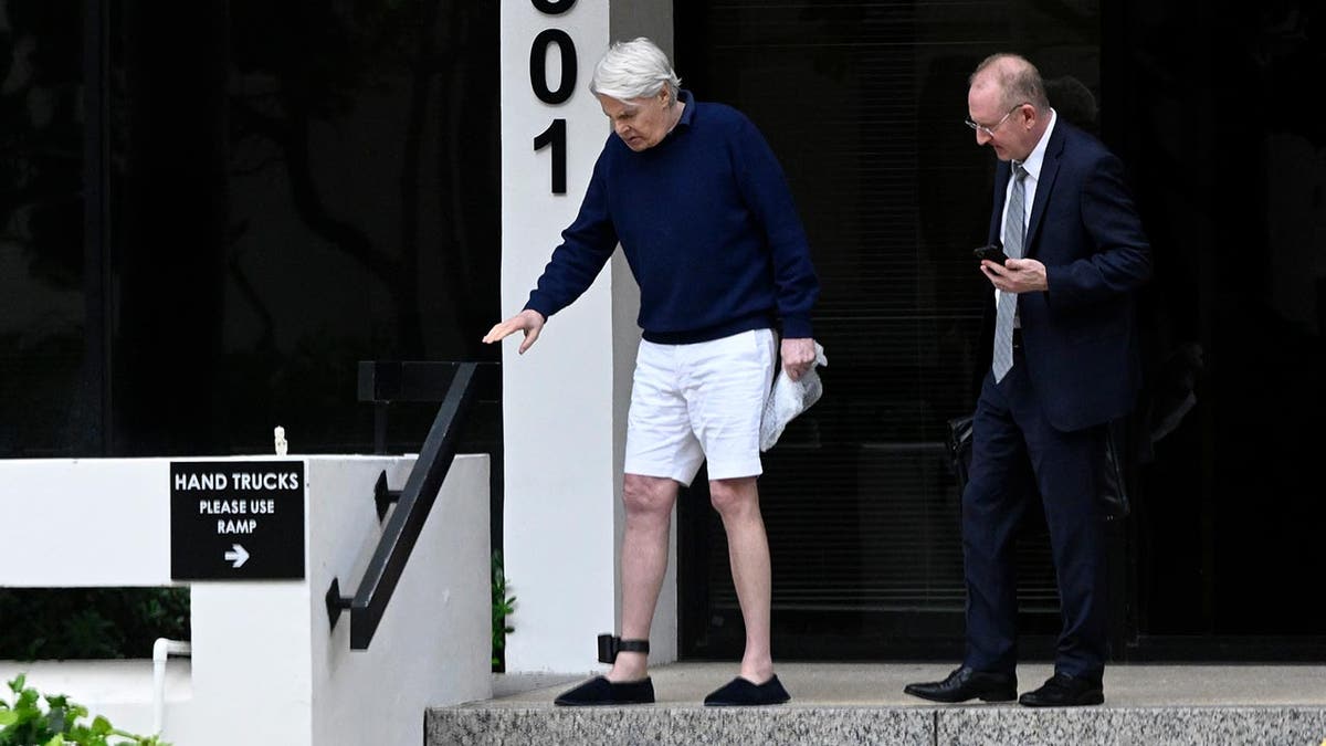 An ankle show fitted to nan limb of erstwhile Abercrombie and Fitch CEO Mike Jeffries is visible arsenic he walks distant from an agency building.