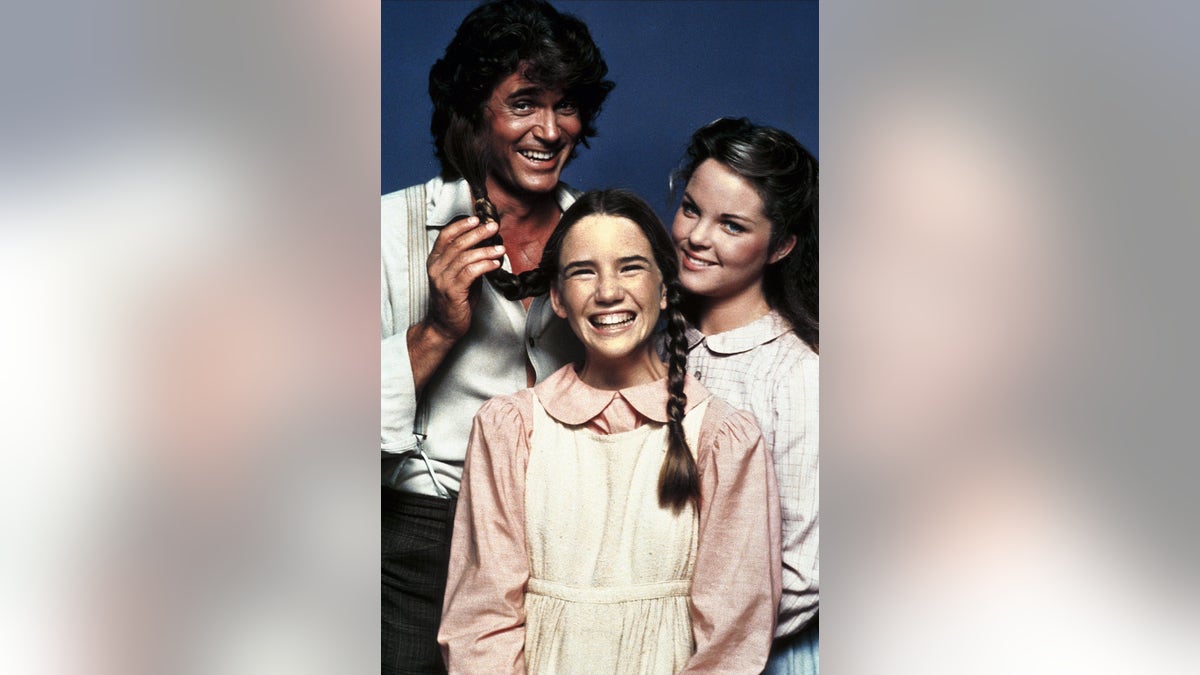 Michael Landon playing with Melissa Gilbert's pigtails.