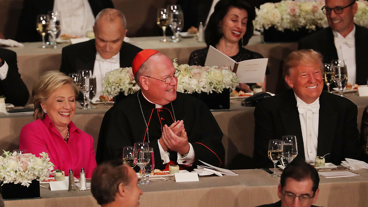 Cardinal Dolan betwixt  Hillary Clinton and Donald Trump astatine  2016 Al Smith dinner