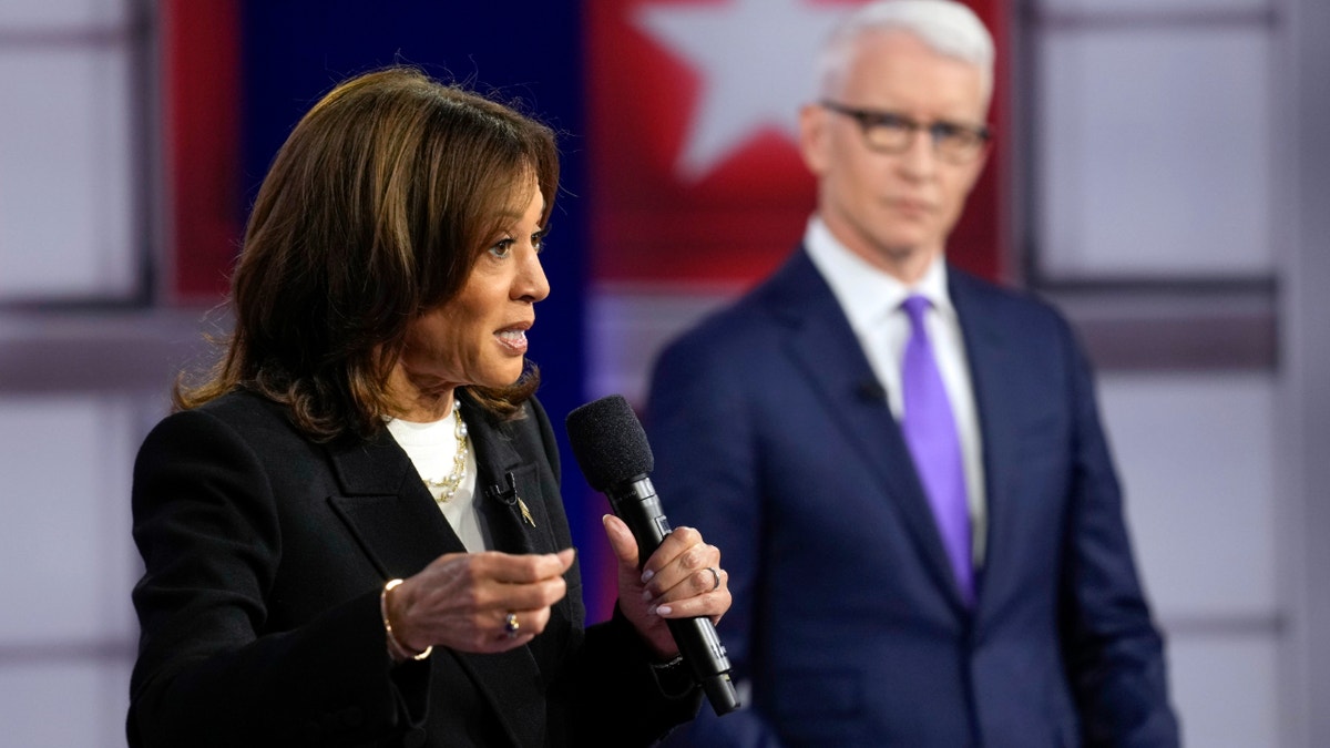 Harris speaks alongside CNN's Anderson Cooper at a town hall event in Pennsylvania.