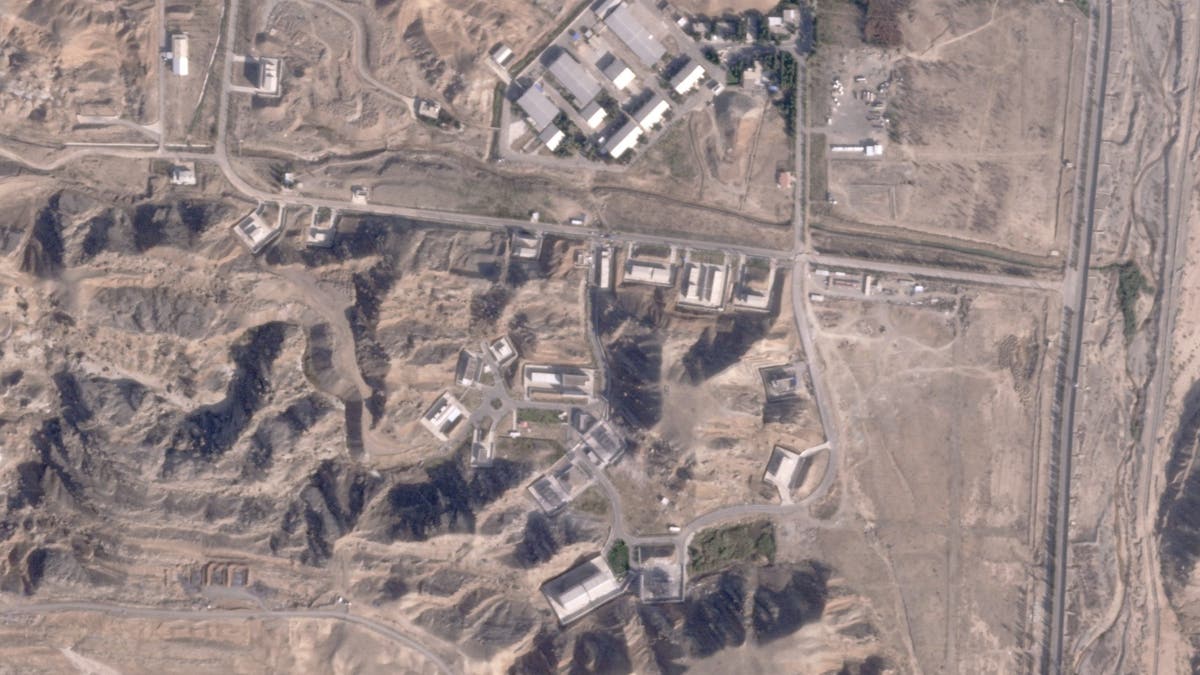 This satellite photo from Planet Labs PBC shows damaged buildings at the Iranian Parchin military base on the outskirts of Tehran, Iran, Sunday, Oct. 27, 2024. An Israeli strike on Iran damaged facilities at a secret military base southeast of the capital Iranian experts in the past have been linked to Tehran's former nuclear weapons program and another base linked to its ballistic missile program, satellite photos analyzed Sunday by The Associated Press show. The damaged structures are located in the lower right corner and lower center of the image. 