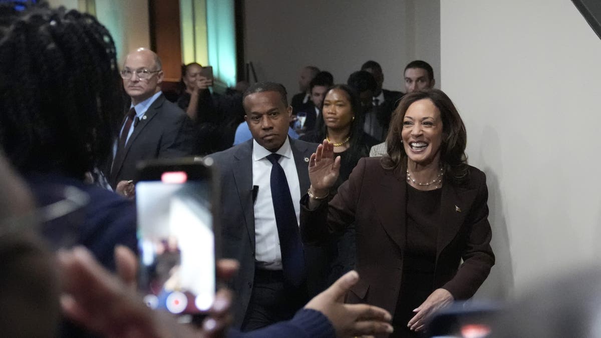 Harris waves as he leaves a church in Philadelphia