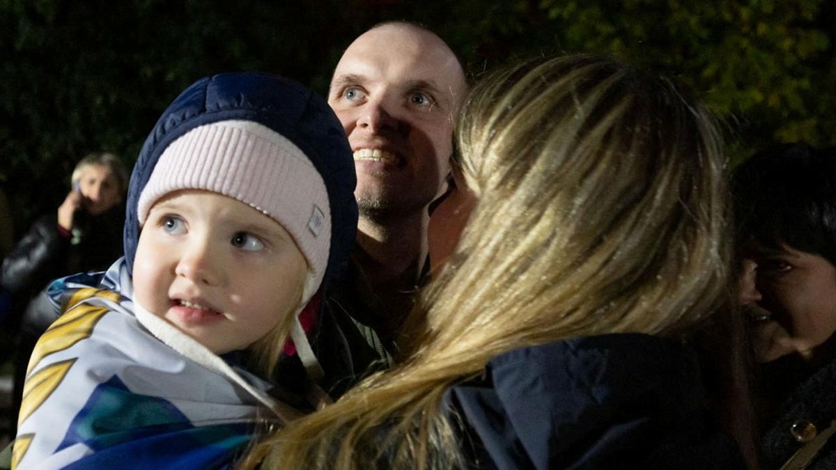 A Ukrainian prisoner of war (POW) stands with his relatives after a swap, amid Russia's attack on Ukraine, in an undisclosed location in Ukraine, in this handout picture obtained on Oct. 19, 2024.?